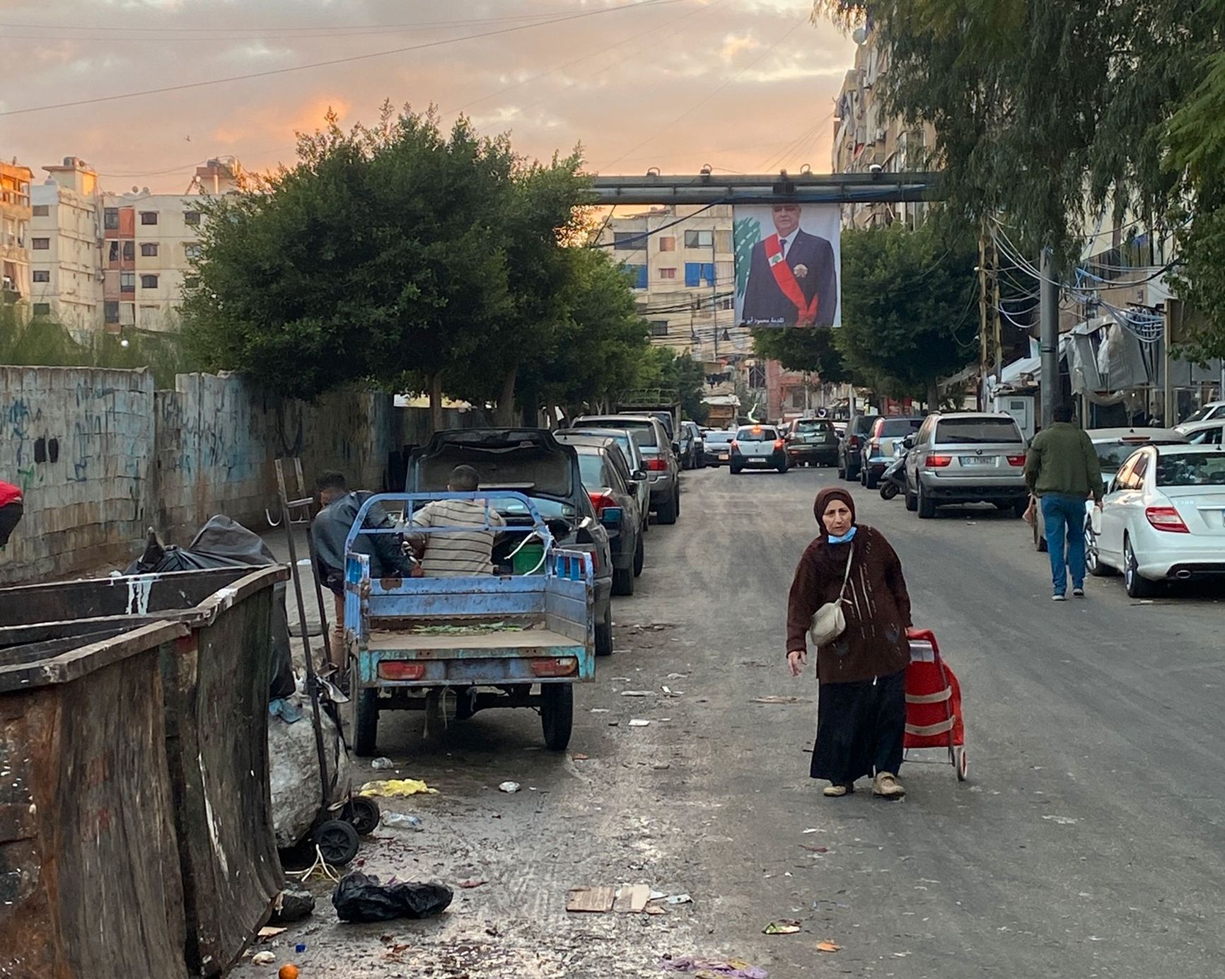 A woman stands in front of the president's portrait in the Shiite neighborhood of Dahieh, a Hezbollah stronghold in Beirut